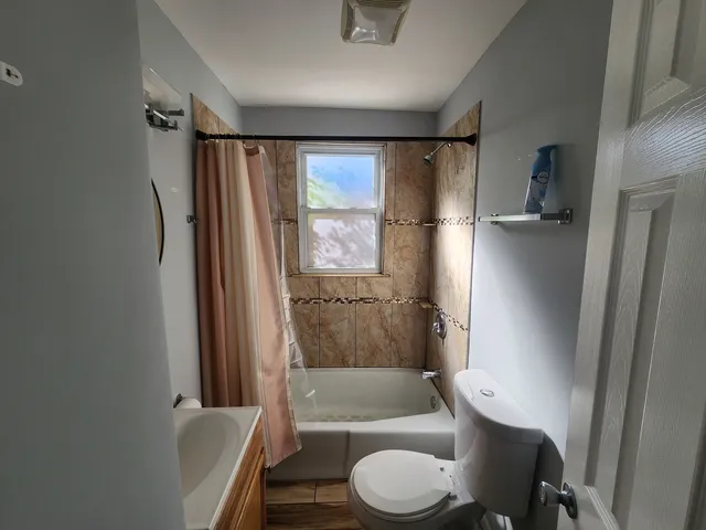 a bathroom with a toilet and a shower