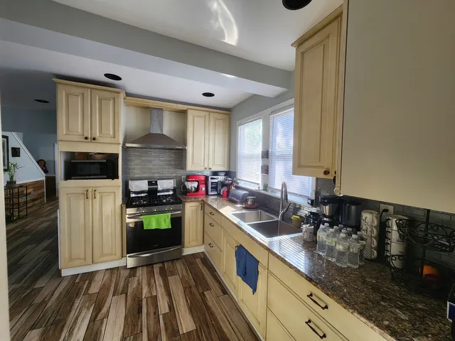 a kitchen with a sink stove and cabinets