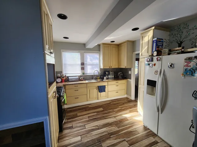 a kitchen with cabinets a refrigerator and a stove