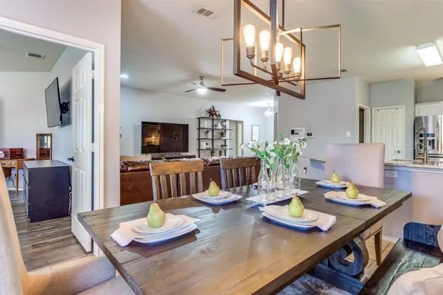 a view of a dining room with furniture and a table