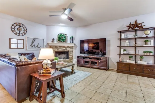 a living room with furniture a flat screen tv and a fireplace