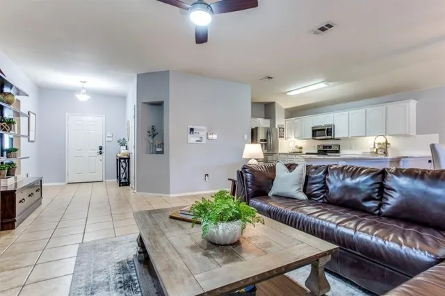 a living room with furniture and a chandelier