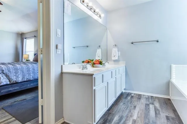 a hallway with a dresser and a wooden floor