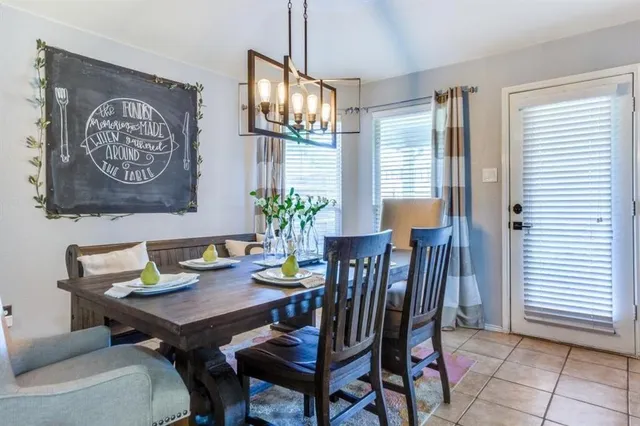 a view of a dining room with furniture and a potted plant