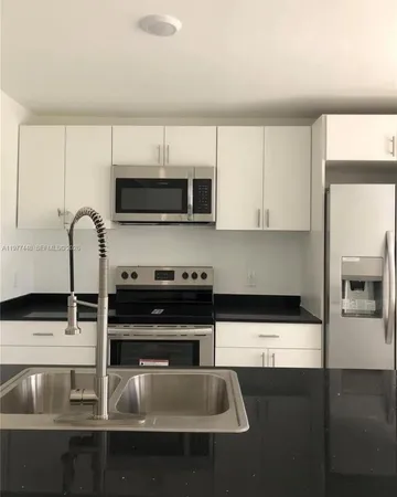 a kitchen with a sink and cabinets