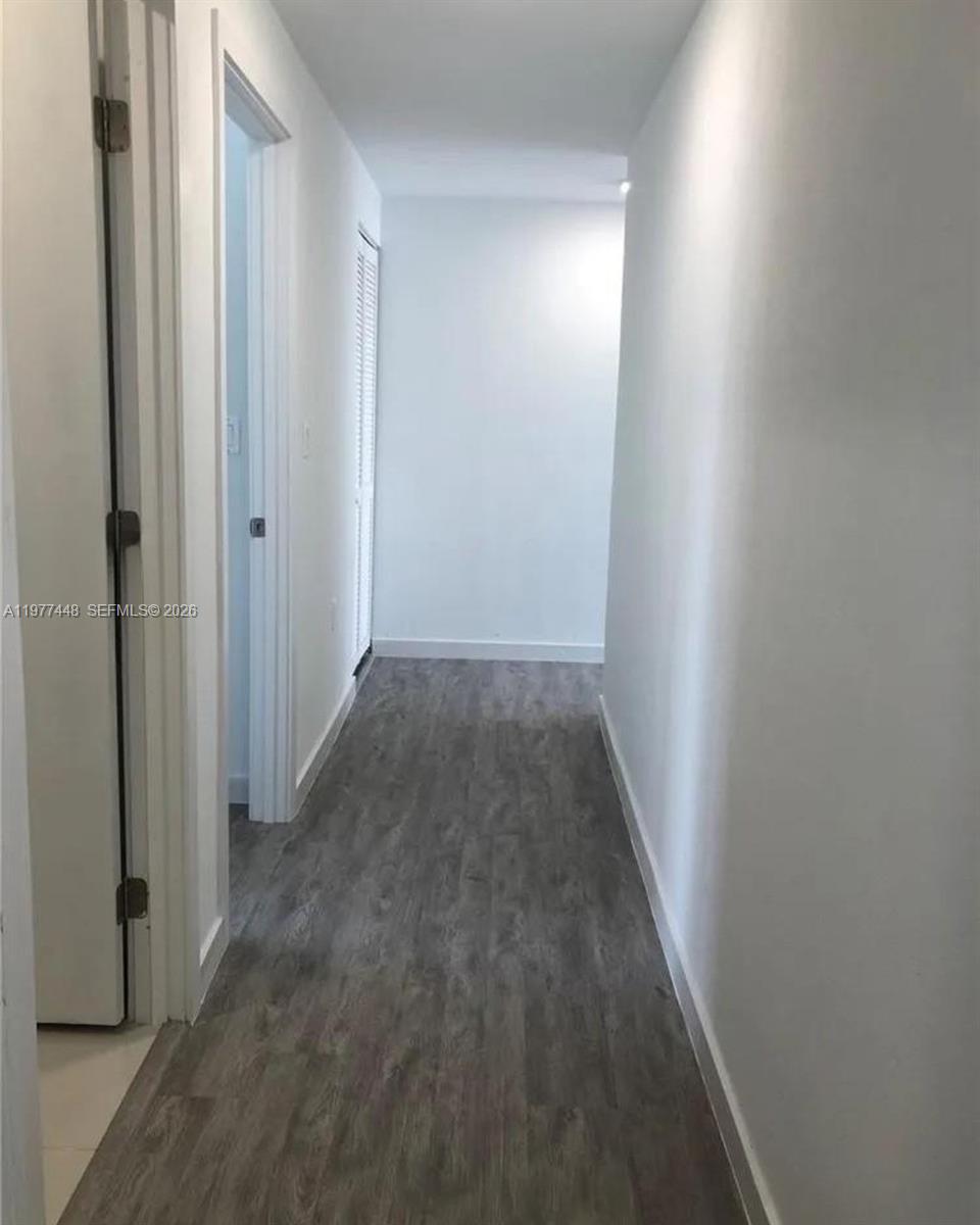 25869 Southwest 139th Path Homestead, FL 33032 - Photo 4 of 17 a view of a hallway with wooden floor
