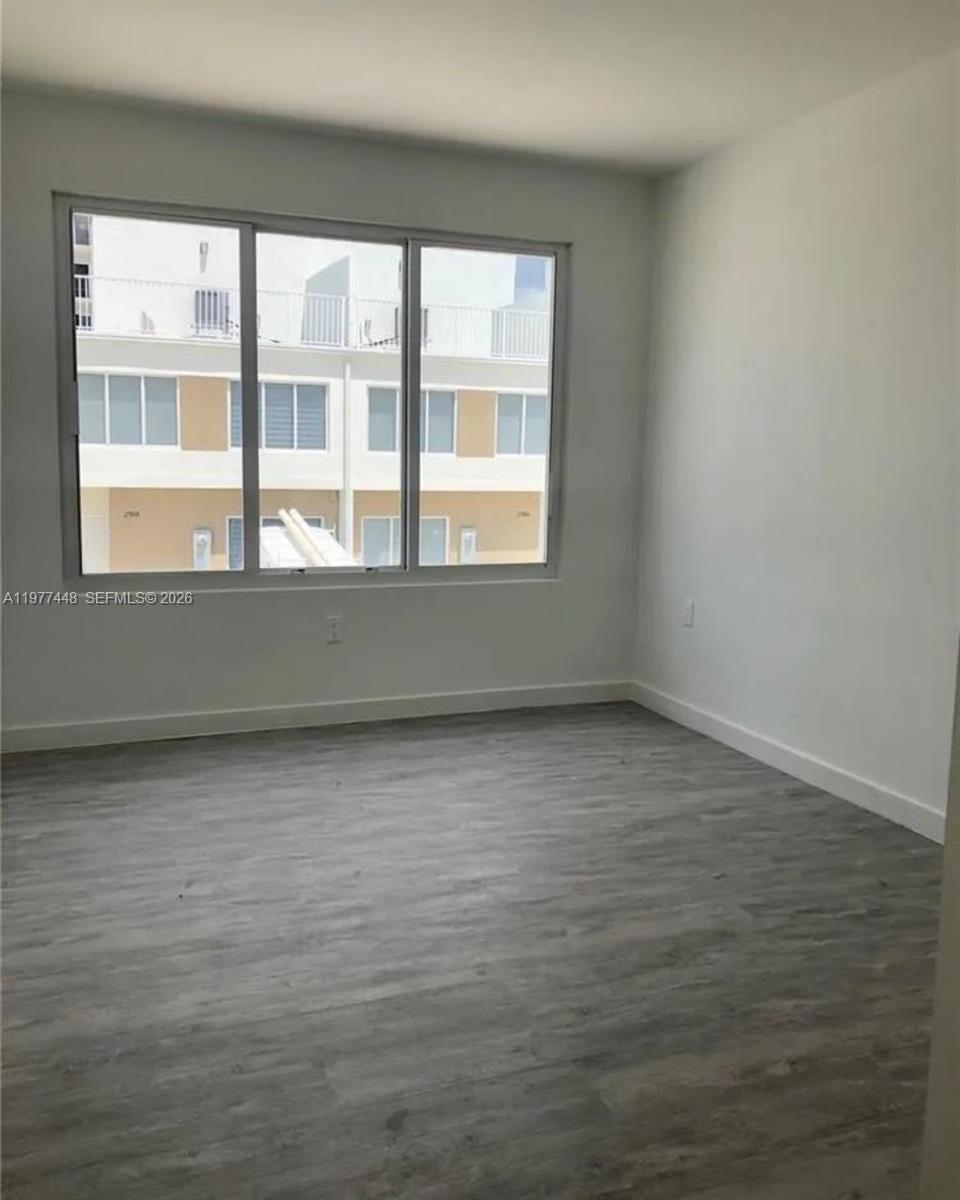 25869 Southwest 139th Path Homestead, FL 33032 - Photo 7 of 17 an empty room with a window