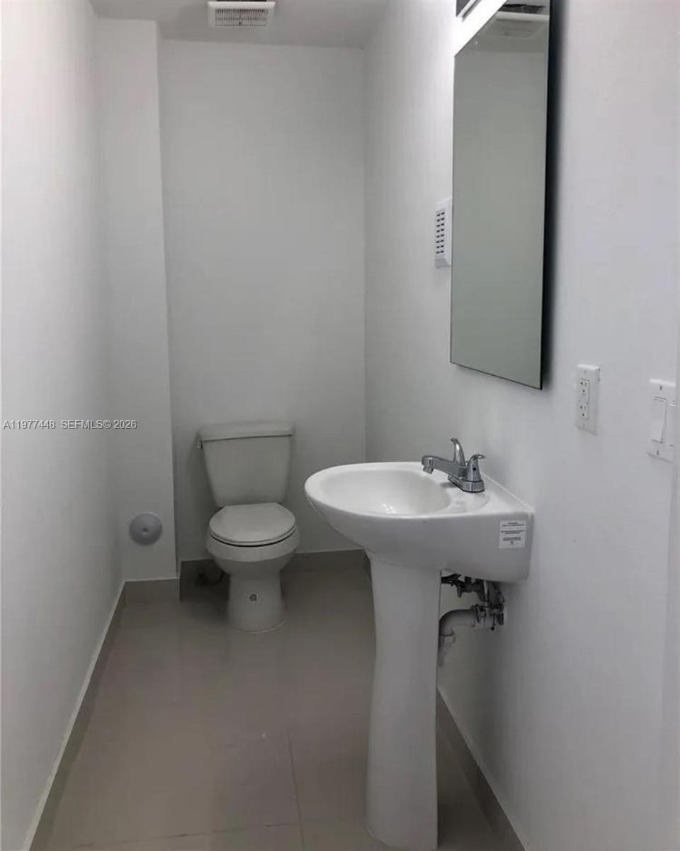 25869 Southwest 139th Path Homestead, FL 33032 - Photo 9 of 17 a bathroom with a sink toilet and mirror