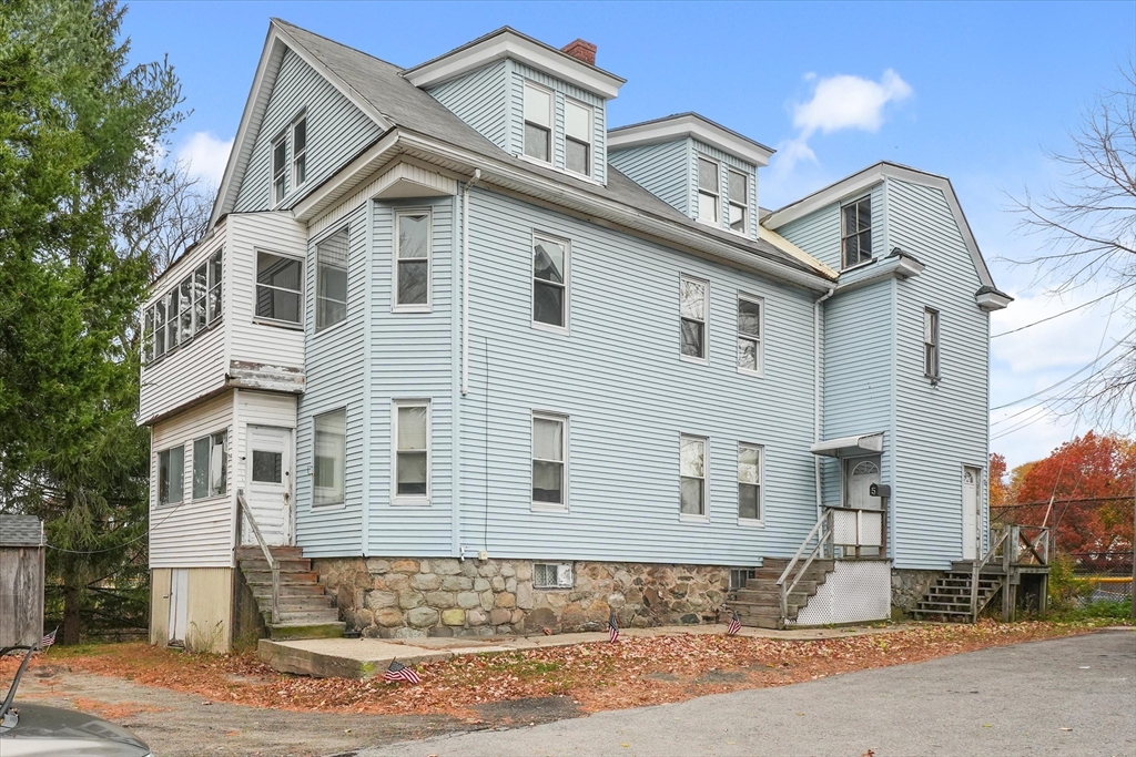 5-7 Arlington Terrace Lawrence, MA 01841 - Photo 1 of 39 a front view of a house with a yard