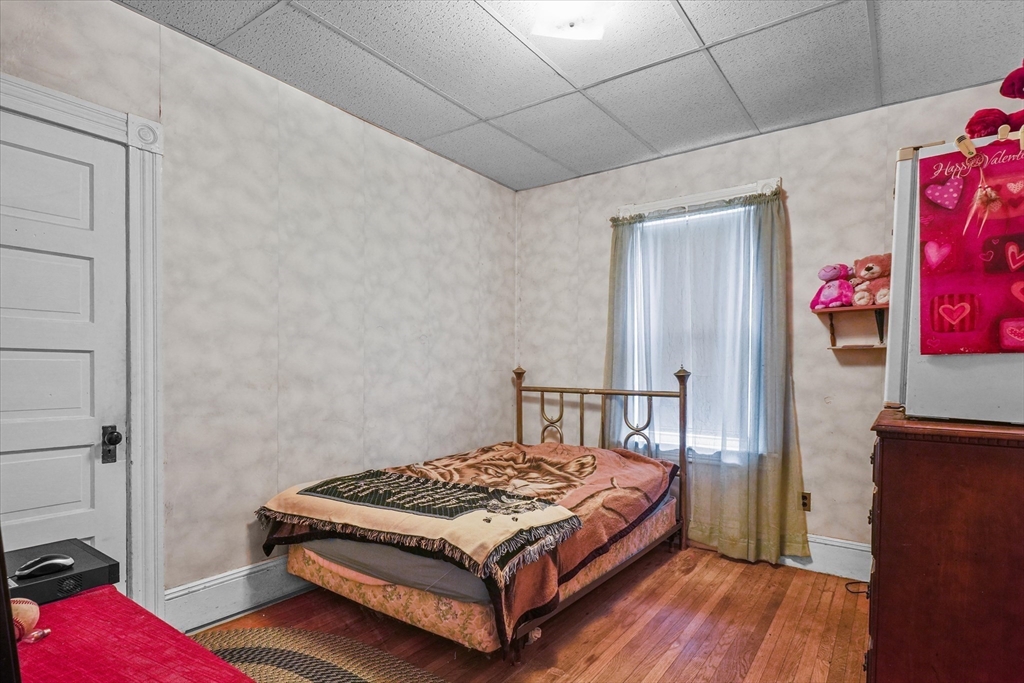 5-7 Arlington Terrace Lawrence, MA 01841 - Photo 15 of 39 a bedroom with a bed and a dresser