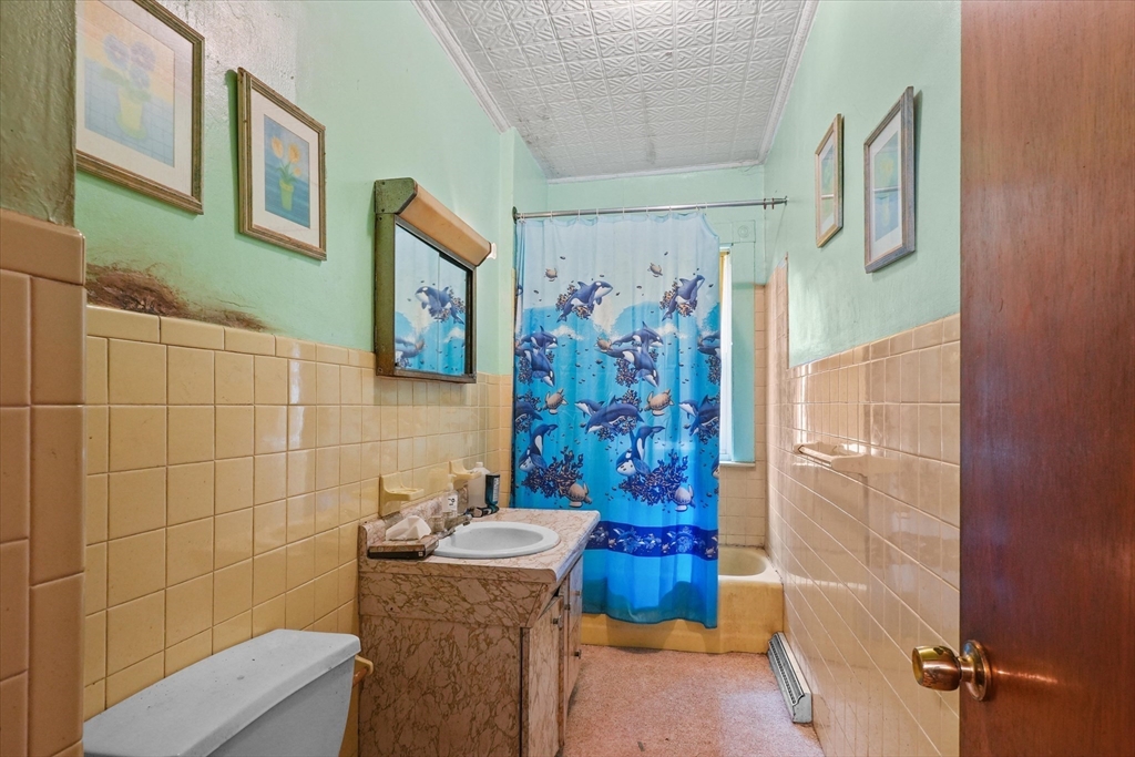 5-7 Arlington Terrace Lawrence, MA 01841 - Photo 17 of 39 a bathroom with a shower and a toilet