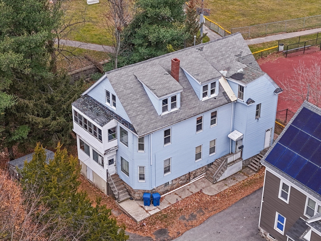 5-7 Arlington Terrace Lawrence, MA 01841 - Photo 2 of 39 front view of a house with a yard