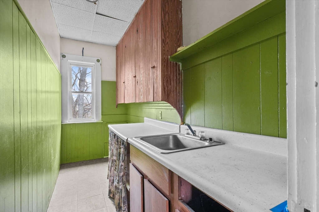 5-7 Arlington Terrace Lawrence, MA 01841 - Photo 26 of 39 a bathroom with a sink and a mirror
