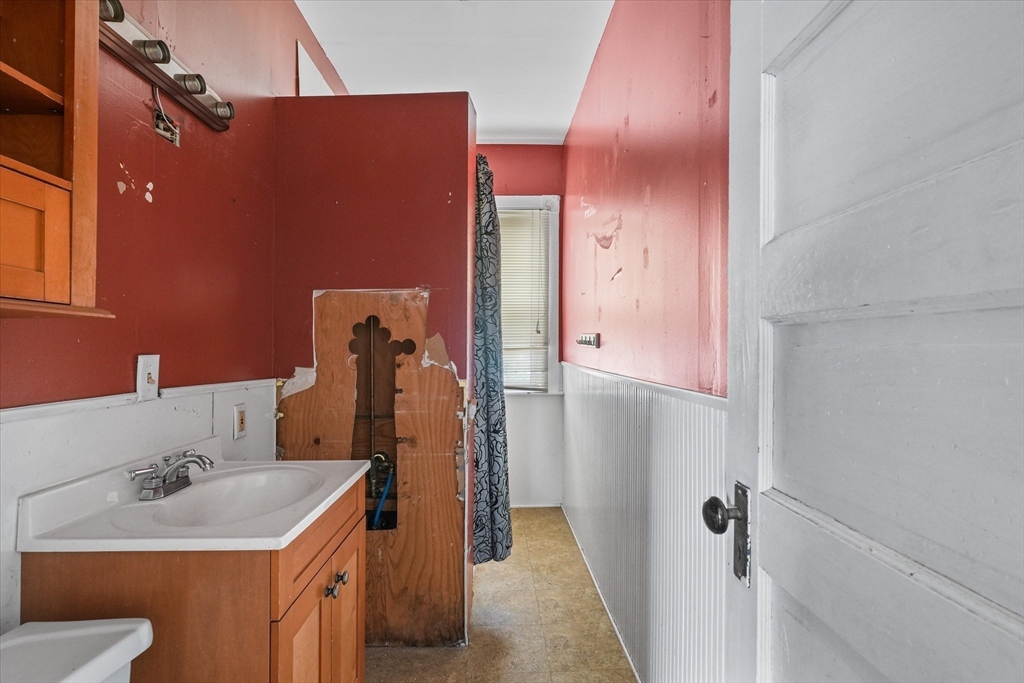 5-7 Arlington Terrace Lawrence, MA 01841 - Photo 27 of 39 a bathroom with a sink toilet and shower