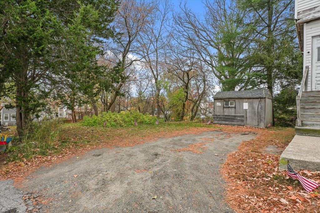 5-7 Arlington Terrace Lawrence, MA 01841 - Photo 7 of 39 a front view of a house with a yard and garage