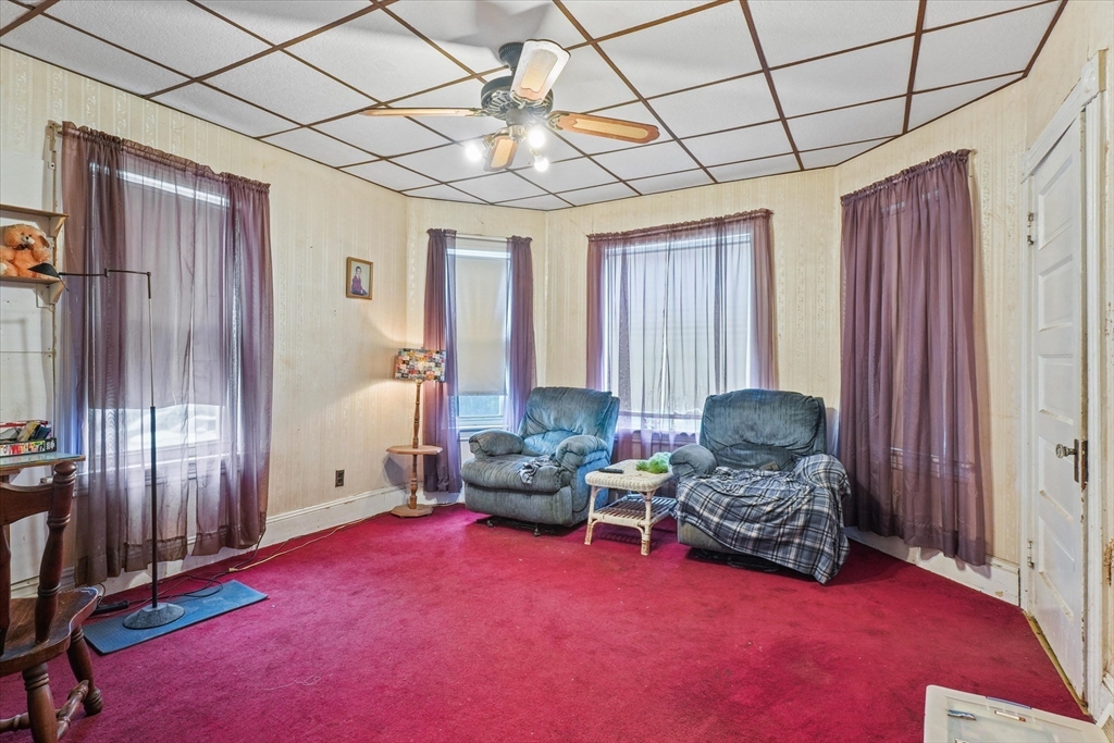 5-7 Arlington Terrace Lawrence, MA 01841 - Photo 10 of 39 a living room with furniture and a chandelier