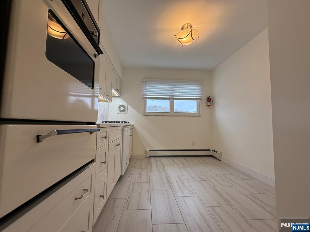 234 Wheeler Street, Unit 2 Cliffside Park, NJ 07010 - Photo 4 of 9 a view of hallway with stairs and wooden floor