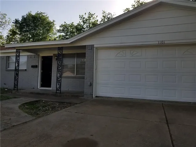a front view of a house with garage