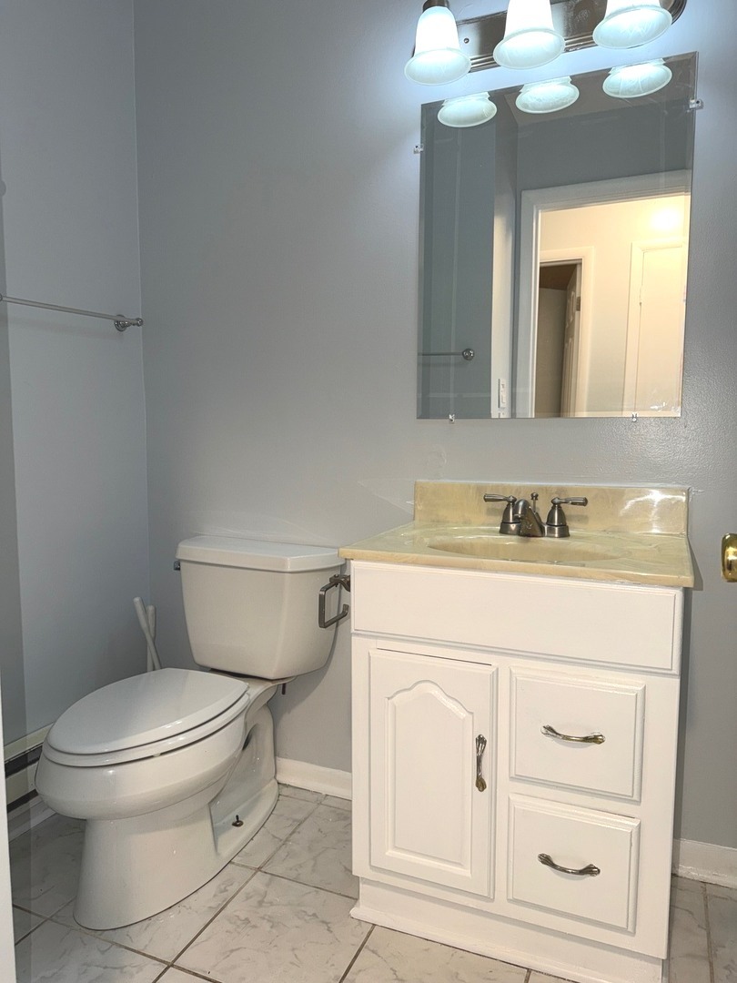 1110 18th Street, Unit 1E Broadview, IL 60155 - Photo 14 of 20 a bathroom with a toilet sink vanity and granite