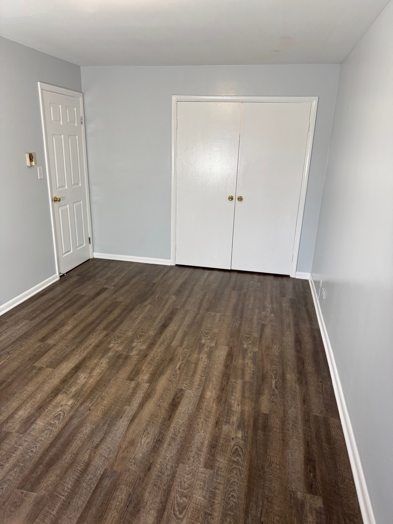 1110 18th Street, Unit 1E Broadview, IL 60155 - Photo 10 of 20 a view of an empty room with wooden floor and closet