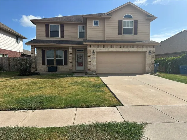 a view of house with yard and front view of a house