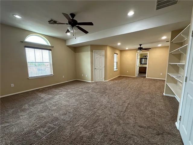 a view of a livingroom with a ceiling fan and window