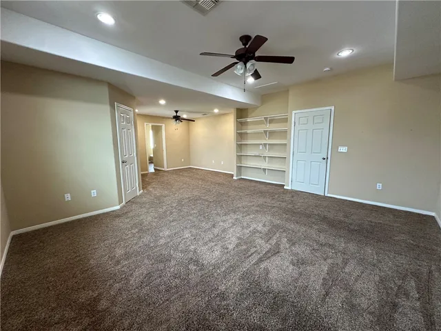 a view of a livingroom with a ceiling fan and window