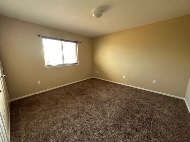 an empty room with a empty space and windows