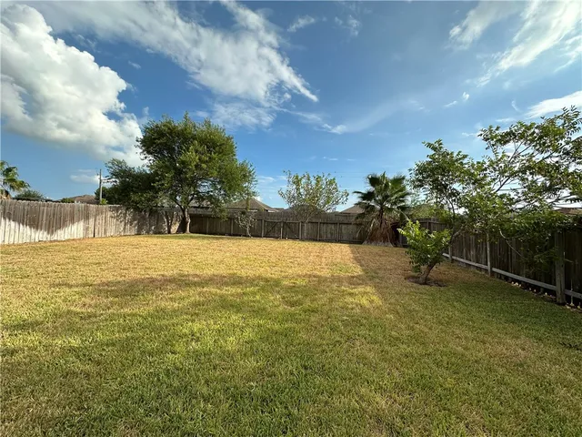 a view of yard with swimming pool and green space