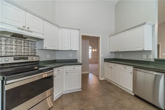 a kitchen with cabinets appliances and a sink