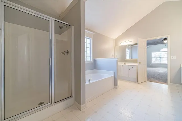 a spacious bathroom with a bathtub shower and toilet