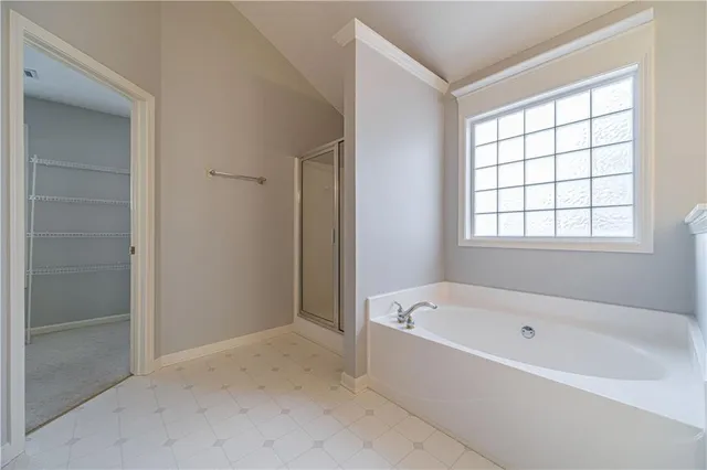a white bath tub sitting in a bathroom next to a window
