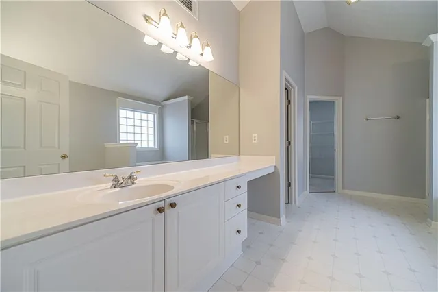 a bathroom with a sink a vanity and a mirror