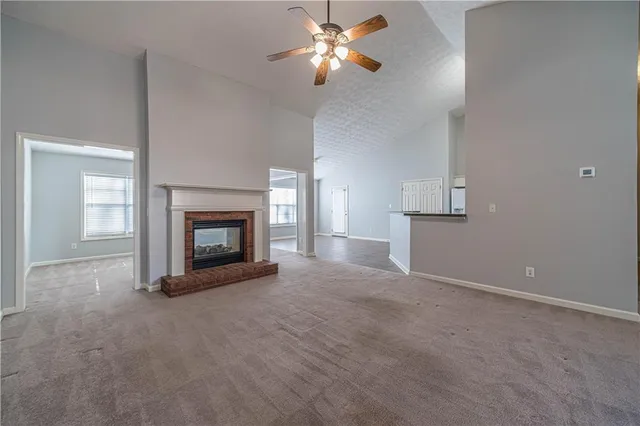 a view of empty room with fireplace and fan