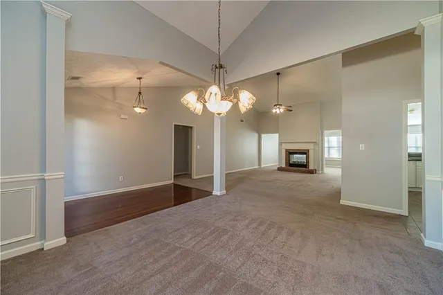 a view of a livingroom with a chandelier fan and a large mirror