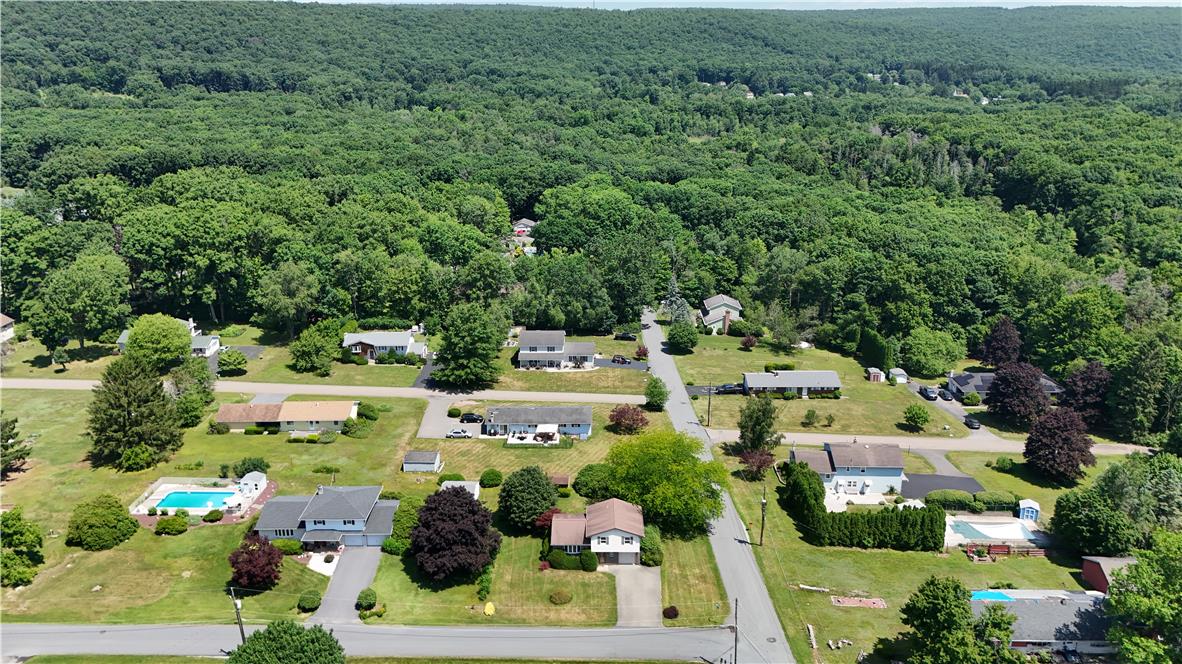 21 Will Barnesville, PA 18214 - Photo 23 of 23 An aerial perspective reveals a serene neighborhood nestled against a dense forest backdrop, with homes featuring inviting private pools.