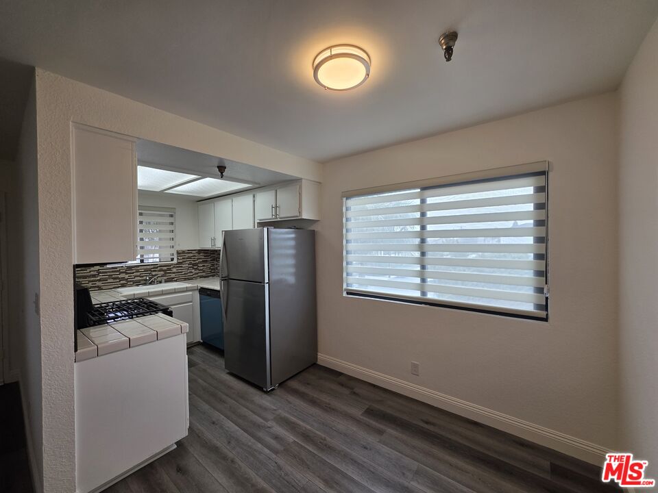 3204 139th Street, Unit 6 Hawthorne, CA 90250 - Photo 15 of 37 a kitchen with a refrigerator and a stove top oven