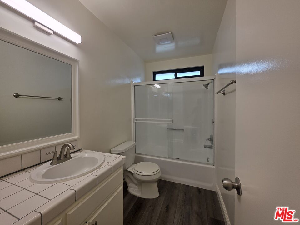 3204 139th Street, Unit 6 Hawthorne, CA 90250 - Photo 32 of 37 a bathroom with a granite countertop sink toilet a mirror and shower