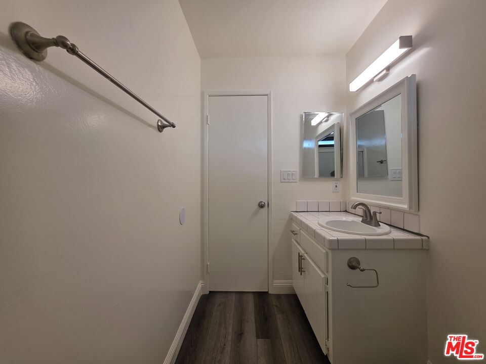 3204 139th Street, Unit 6 Hawthorne, CA 90250 - Photo 34 of 37 a bathroom with a sink and mirror with toilet