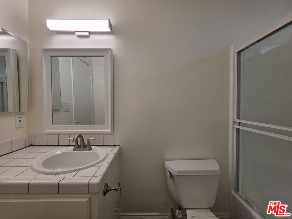 3204 139th Street, Unit 6 Hawthorne, CA 90250 - Photo 36 of 37 a bathroom with a sink a toilet and a mirror