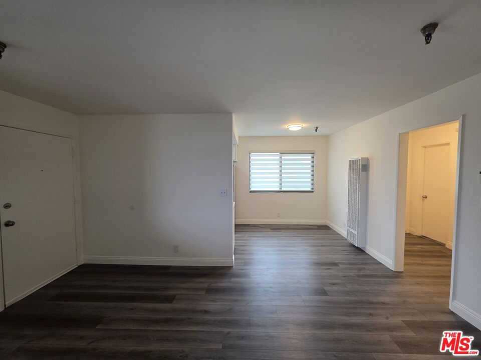 3204 139th Street, Unit 6 Hawthorne, CA 90250 - Photo 4 of 37 a view of an empty room with wooden floor and a window