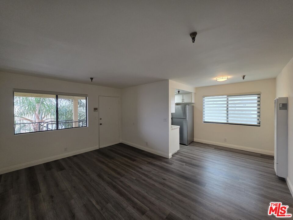 3204 139th Street, Unit 6 Hawthorne, CA 90250 - Photo 5 of 37 an empty room with wooden floor and windows