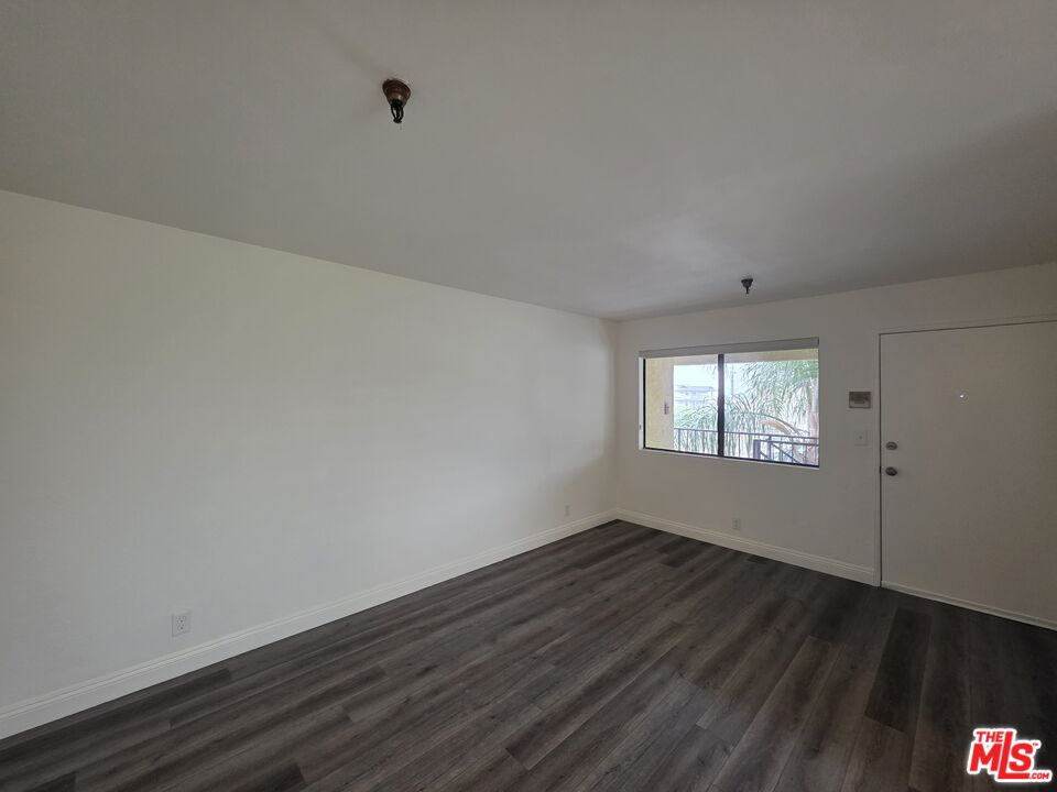 3204 139th Street, Unit 6 Hawthorne, CA 90250 - Photo 7 of 37 an empty room with wooden floor and windows