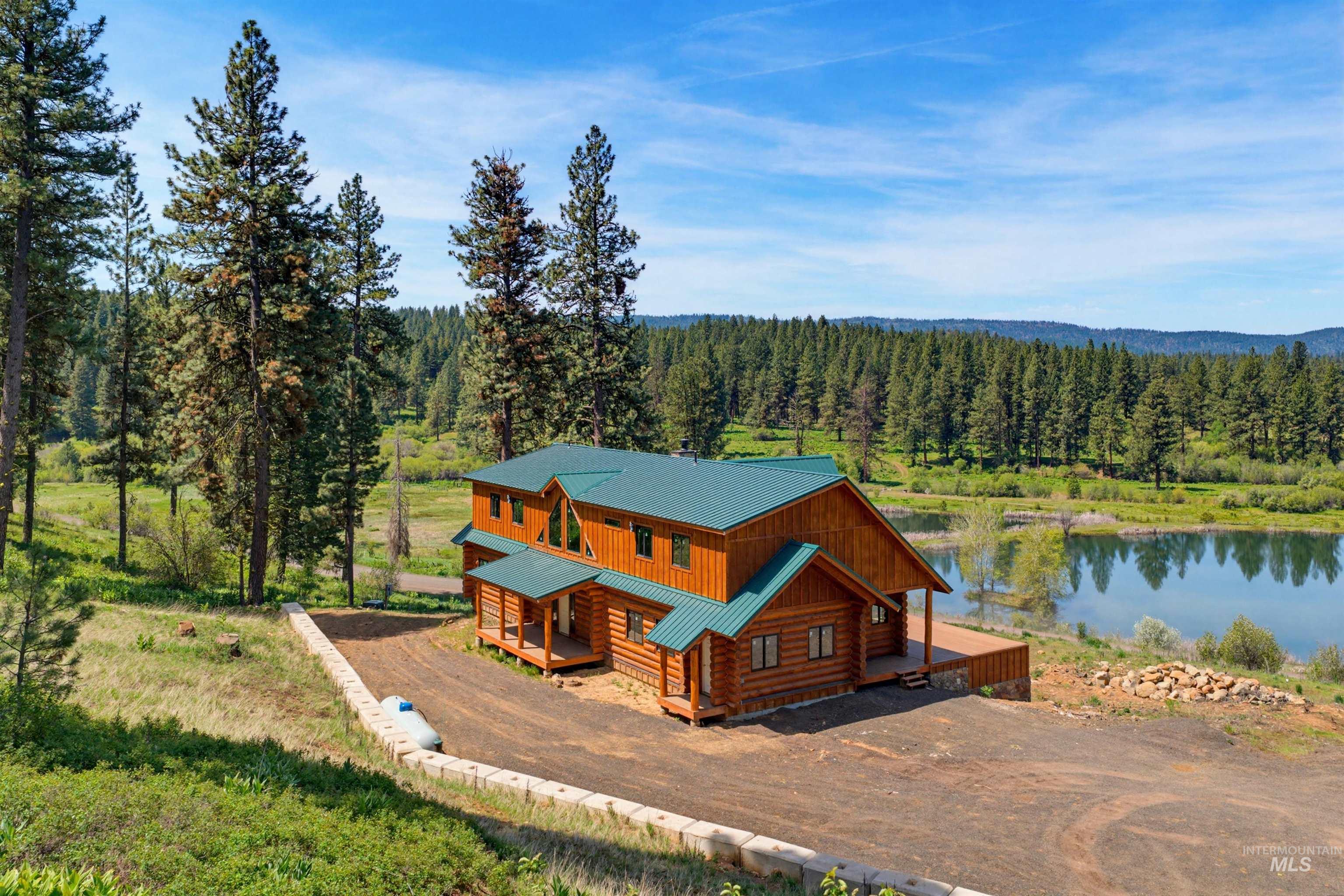 3322 Big Creek Road New Meadows, ID 83654 - Photo 5 of 50 Log home with a green metal roof and expansive surrounding acreage