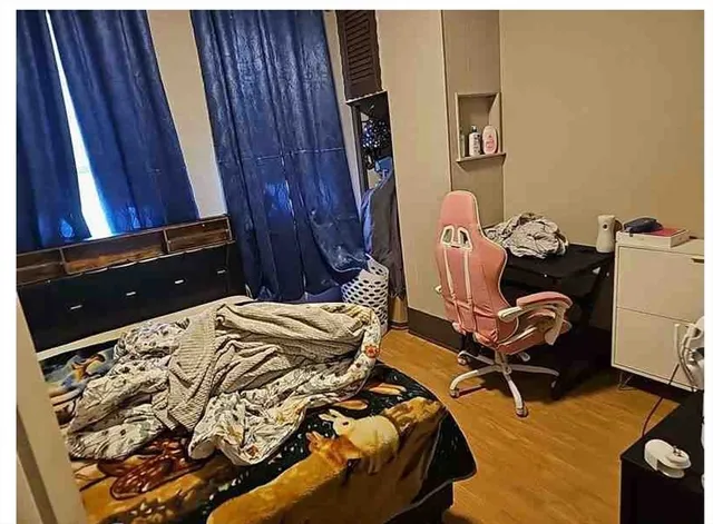 a bedroom with a bed and a mirror