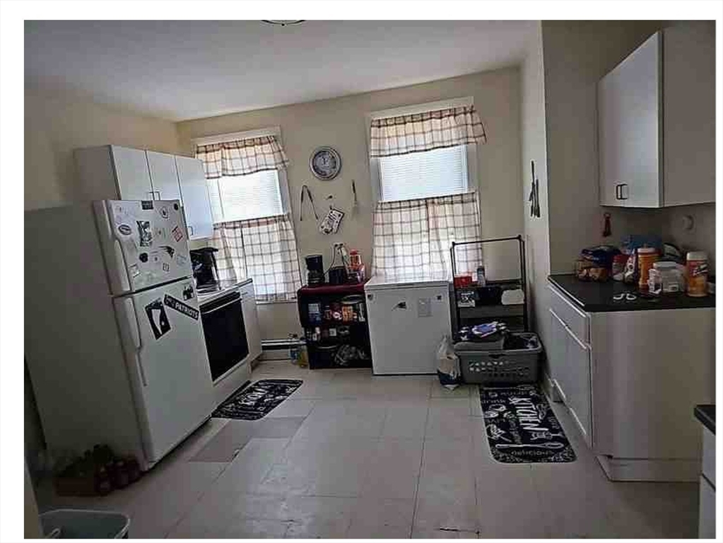 86 West Main Street North Adams, MA 01247 - Photo 14 of 35 a kitchen with stainless steel appliances a refrigerator a sink a stove and white cabinets