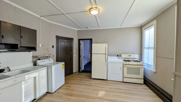 a kitchen with a refrigerator sink stove and cabinets