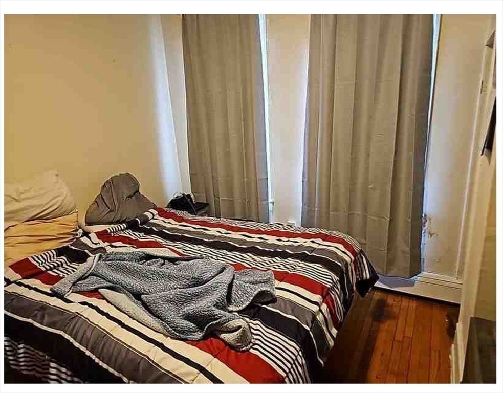 86 West Main Street North Adams, MA 01247 - Photo 17 of 35 a bed sitting in a bedroom next to a window