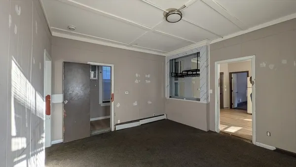 a view of a hallway with wooden shelves