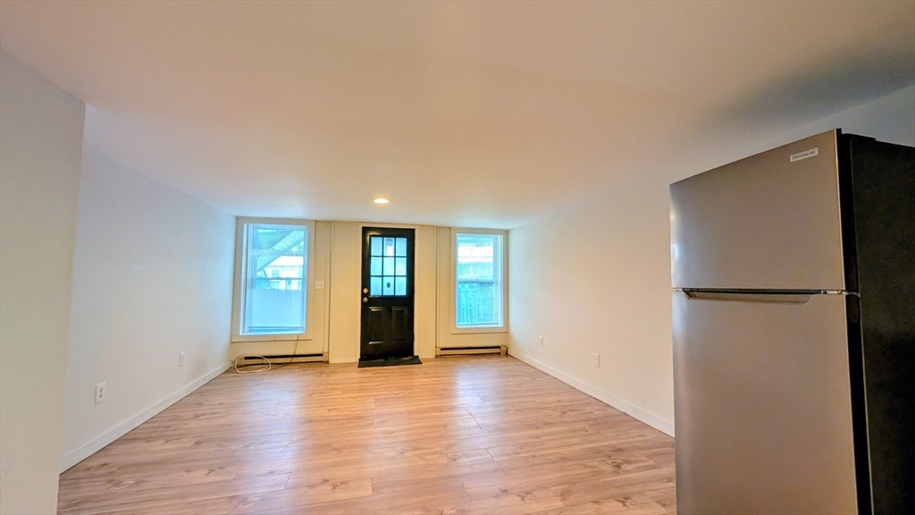 86 West Main Street North Adams, MA 01247 - Photo 4 of 35 a view of an empty room with window and wooden floor